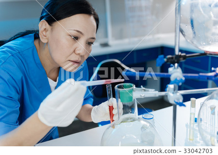 Smart professional scientist being focused on the Smart professional scientist being focused on the 33042703
