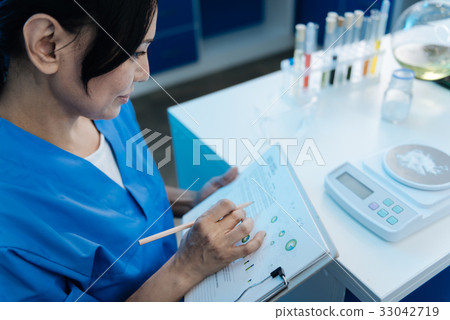 Pleasant smart woman holding notes 33042719