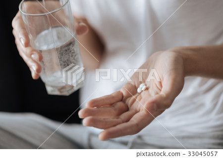 Close up of a palm with pills on it 33045057
