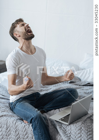Furious angry man holding crumpled paper 33045230