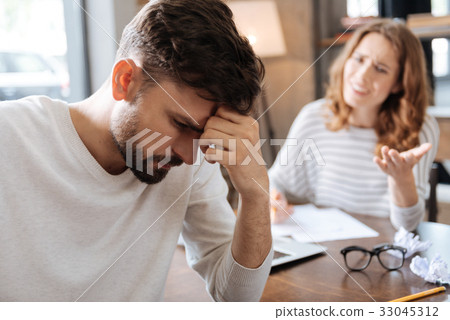 Thoughtful sad man holding his forehead 33045312