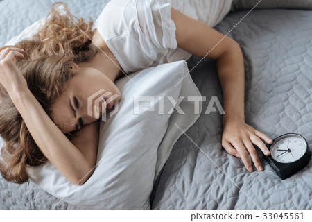Cheerless moody woman getting up in the morning 33045561