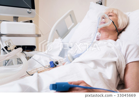 Weak ailing woman getting oxygen for recovery Weak ailing woman getting oxygen for recovery 33045669