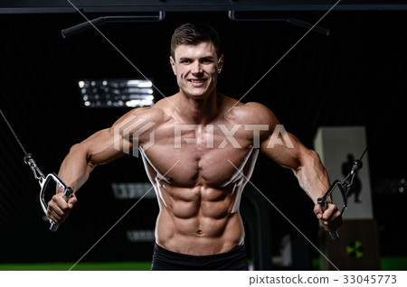 Muscular handsome athletic bodybuilder fitness model posing afte 33045773