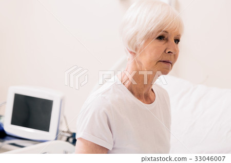 Charming vulnerable aged woman sitting up in Charming vulnerable aged woman sitting up in 33046007