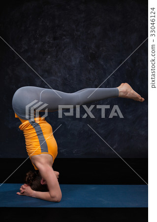 Woman doing Hatha yoga Ashtanga Vinyasa Yoga asana 33046124