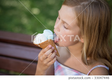 Little girl eating ice cream. Little girl eating ice cream. 33047446