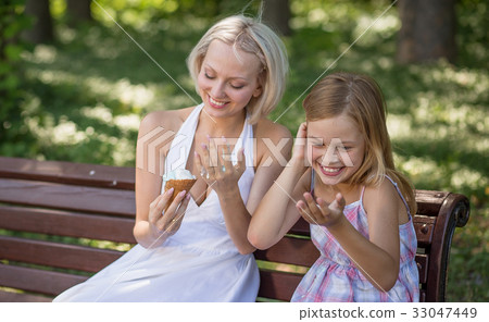 Young mother holding melting ice cream. laughing. 33047449