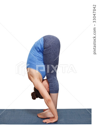 Woman doing yoga asana Uttanasana - standing 33047842