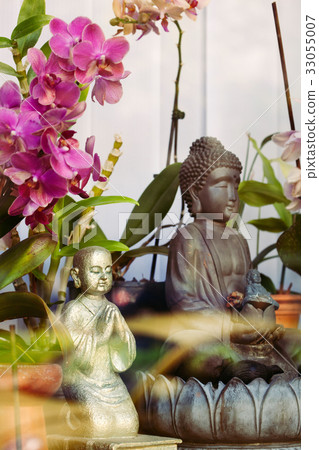 Buddha in meditation with flower 33055007