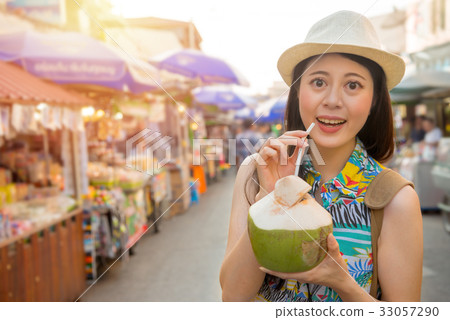 woman traveler holding coconut water 33057290