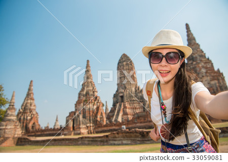 Happy tourist taking camera picture selfie 33059081