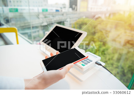 paying with NFC technology on mobile phone 33060612