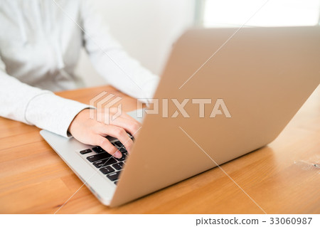 Woman using laptop computer at home 33060987