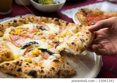 Hand taking out of sliced of pizza 33061341