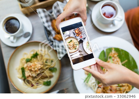 Cellphone taking photo on food from top view 33062946