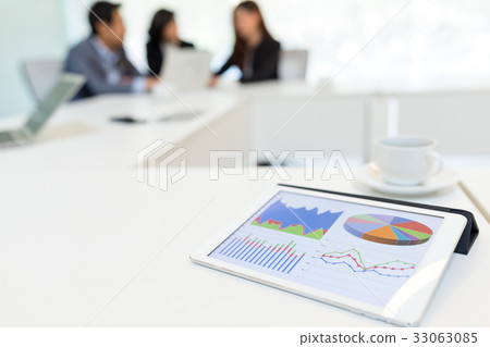 Digital tablet showing data chart in meeting room Digital tablet showing data chart in meeting room 33063085