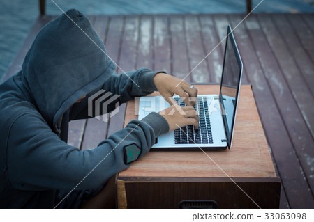 man wearing a hooded sweatshirt sitting hacker man wearing a hooded sweatshirt sitting hacker 33063098