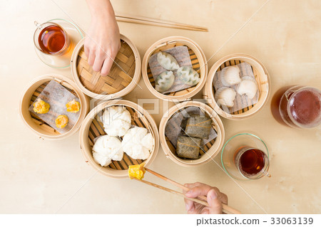 Top view of people eating dim sum Top view of people eating dim sum 33063139