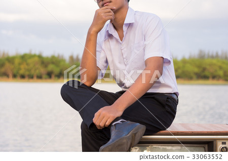 Man sitting on a pier with old televisions. Man sitting on a pier with old televisions. 33063552