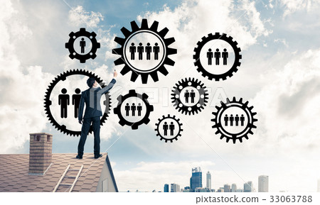 Businessman on house roof presenting teamwork and connection con Businessman on house roof presenting teamwork and connection con 33063788