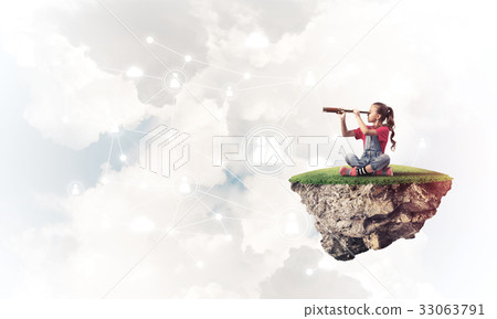 Concept of careless happy childhood with girl looking in spyglas 33063791