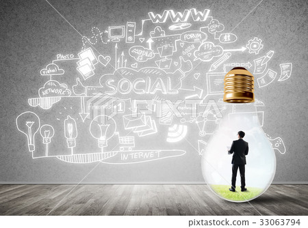 Businessman trapped in bulb Businessman trapped in bulb 33063794