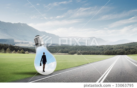 Businesswoman inside light bulb Businesswoman inside light bulb 33063795