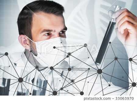 Young scientist mixing reagents in glass flask in clinical laboratory Young scientist mixing reagents in glass flask in clinical laboratory 33063970