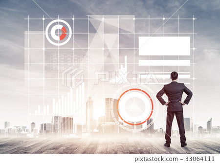 Pensive businessman looking at user interface against modern cit 33064111