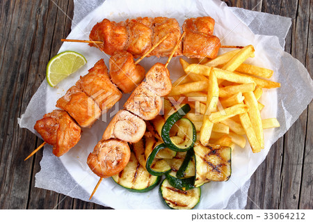 chicken shish kebabs with french fries 33064212