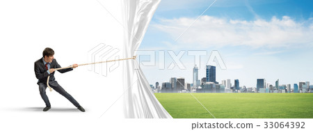 Young man opening white curtain and presenting modern city landscape 33064392