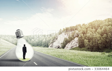 Businessman inside light bulb Businessman inside light bulb 33064464