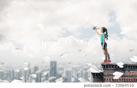 Concept of careless happy childhood with girl dreaming to become 33064510