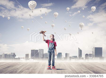 Concept of careless happy childhood with girl dreaming about som 33064785