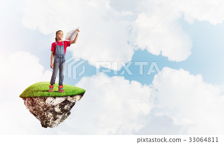 Concept of careless happy childhood with girl throwing paper plane Concept of careless happy childhood with girl throwing paper plane 33064811