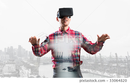 Guy wearing checked shirt and virtual mask stretching hands and trying to concentrate Guy wearing checked shirt and virtual mask stretching hands and trying to concentrate 33064820