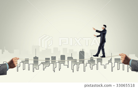 Business concept of risk support and assistance with man balancing on rope 33065518