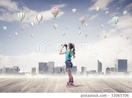 Concept of careless happy childhood with girl looking in binocul Concept of careless happy childhood with girl looking in binocul 33065706