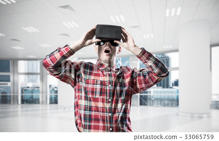 Concept of modern entertaining technologies with man wearing vir 33065759