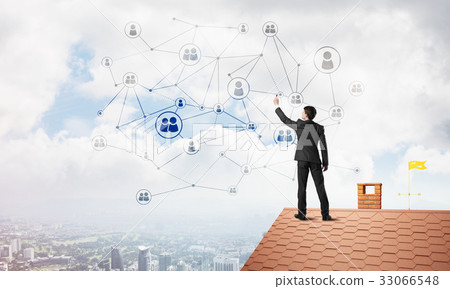 Businessman on house roof presenting networking and connection concept. Mixed media Businessman on house roof presenting networking and connection concept. Mixed media 33066548