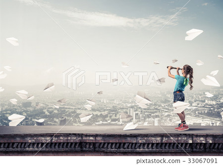 Concept of careless happy childhood with girl exploring this wor 33067091