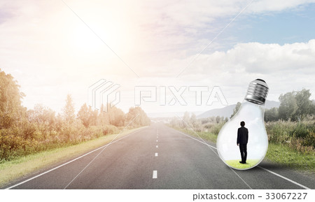 Businessman inside light bulb Businessman inside light bulb 33067227