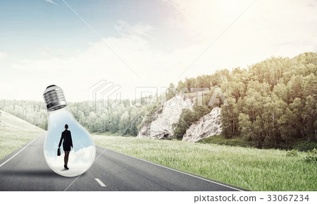 Businesswoman inside light bulb Businesswoman inside light bulb 33067234
