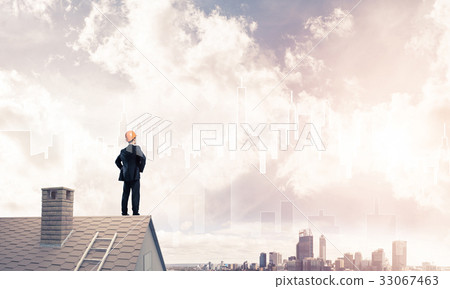 Engineer man standing on roof and looking away. Mixed media Engineer man standing on roof and looking away. Mixed media 33067463