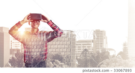 Guy wearing checked shirt and virtual mask demonstrating some em 33067893
