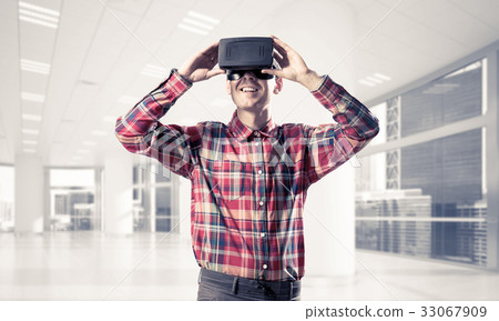 Concept of modern entertaining technologies with man wearing vir Concept of modern entertaining technologies with man wearing vir 33067909
