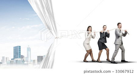 Young businesspeople working in collaboration and pulling white advertisement banner Young businesspeople working in collaboration and pulling white advertisement banner 33067912