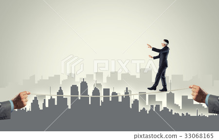 Business concept of risk support and assistance with man balancing on rope 33068165