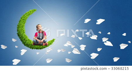 Concept of careless happy childhood with girl on green moon Concept of careless happy childhood with girl on green moon 33068215